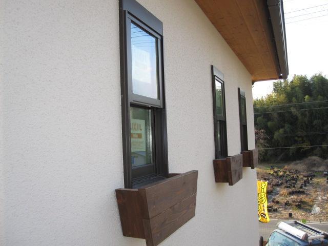 Local appearance photo. Window of flowers with planter. 