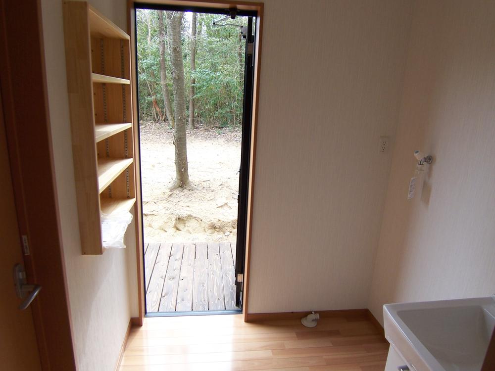 Wash basin, toilet. Entrance door from the good handmade wall storage and washroom user-friendly to the deck. 