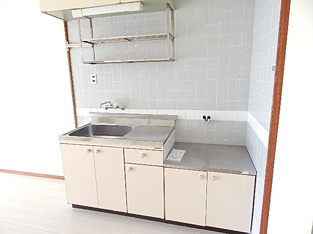 Kitchen. It is with grateful storage shelves at the top
