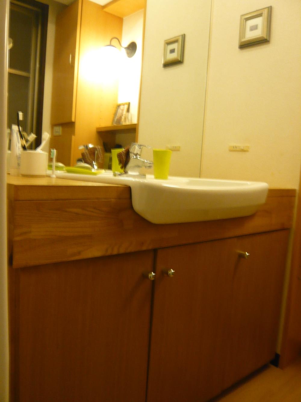 Wash basin, toilet. Stylish vanity with shooting solid wood