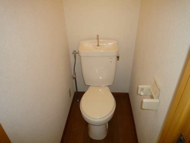 Toilet. The photograph is a corner room.