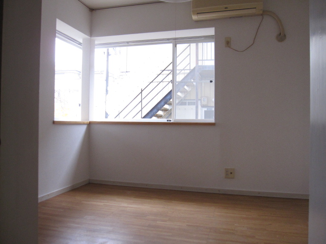 Living and room. It is a bright living room with a wide bay window.