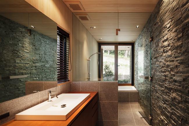 Bathroom. The bathrooms are cypress and stone-clad. Refresh in the bus of the forest views out to the deck. 