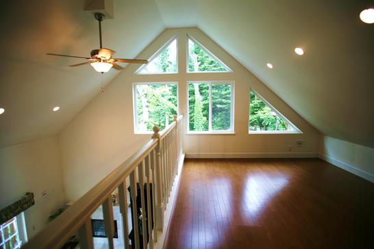 Living. From the second floor loft. Ceiling fan of American House unique.