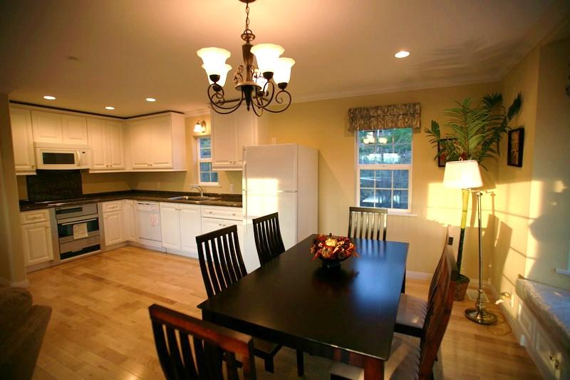 Non-living room. With a table set in the dining space, With making a storage cabinet with a sit-down at the bottom of the bright bay window. 