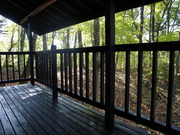 Balcony. Wood deck is at stake is the entire surface of the roof, Sunlight filtering through trees is the state of the pleasant afternoon.