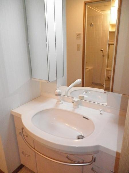 Wash basin, toilet. Bathroom was a white tones