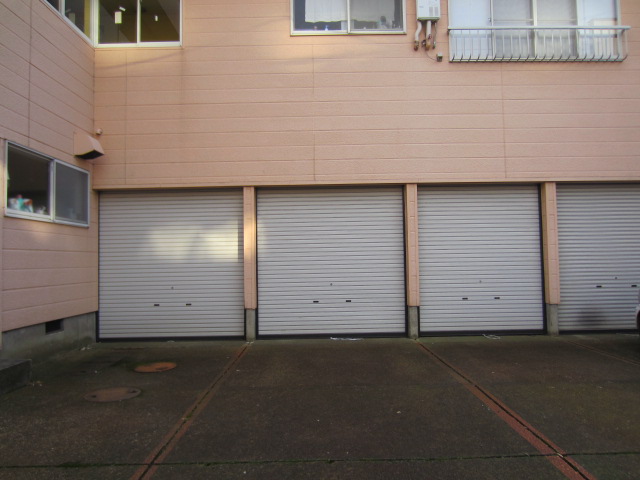 Parking lot. It is a garage with a shutter! 