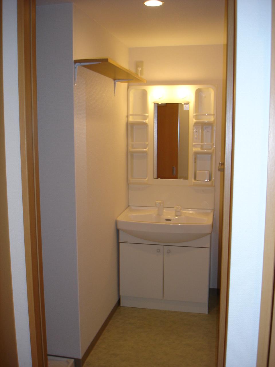 Washroom. Washbasin with shower, With a convenient shelf