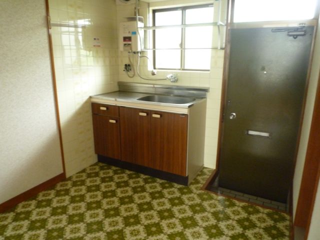 Living and room. Kitchen space of spread. There dish towel hanging.