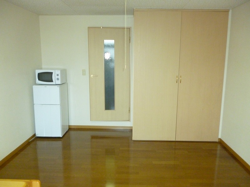 Living and room. microwave, There is also a refrigerator