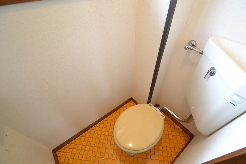 Toilet. It is bright and there is a window.