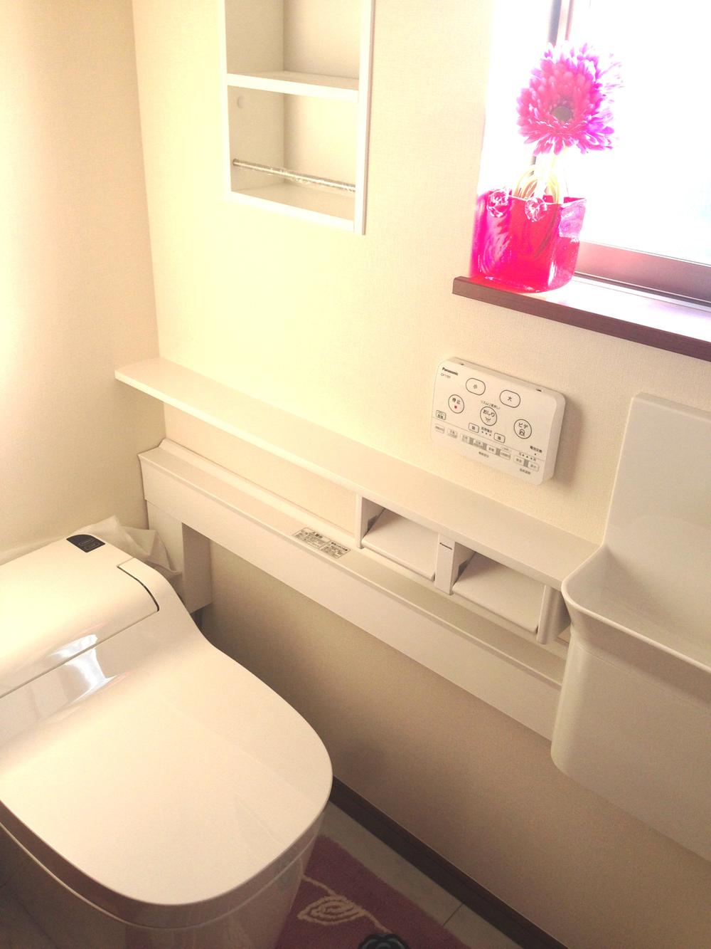 Toilet. Tankless type with a hand washing counter.