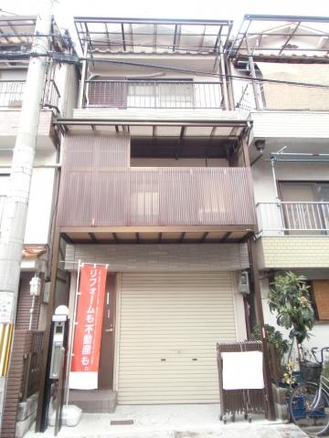 Local appearance photo. Three-story house is