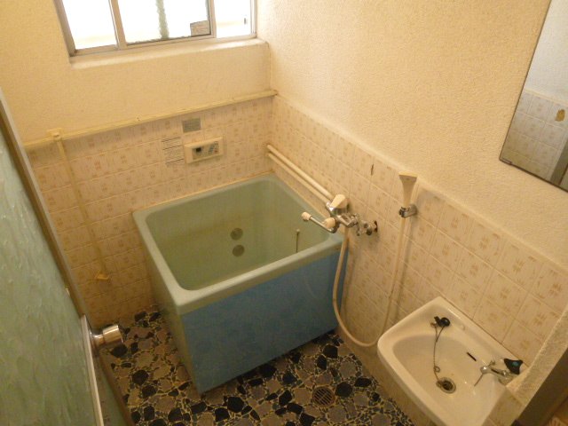 Bath. It is the bathroom equipped with a small window. 