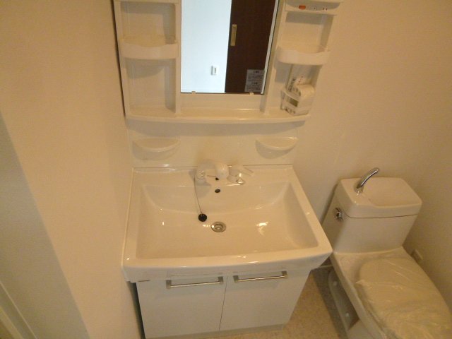 Washroom. Shampoo is a vanity with a dresser. 