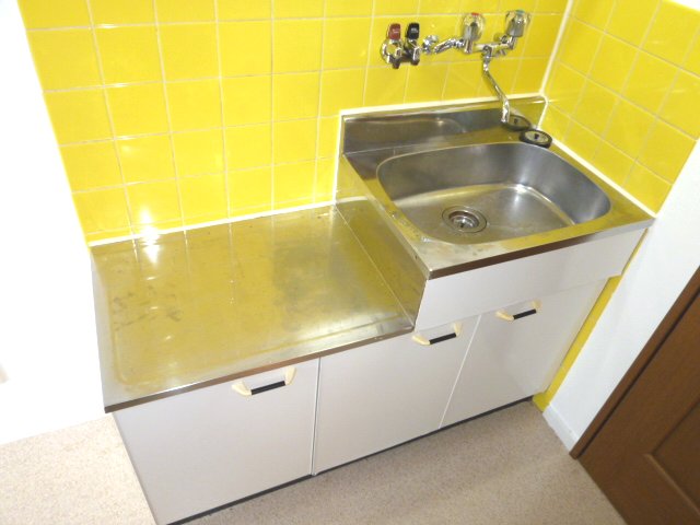 Kitchen. It goes a yellow tile. 