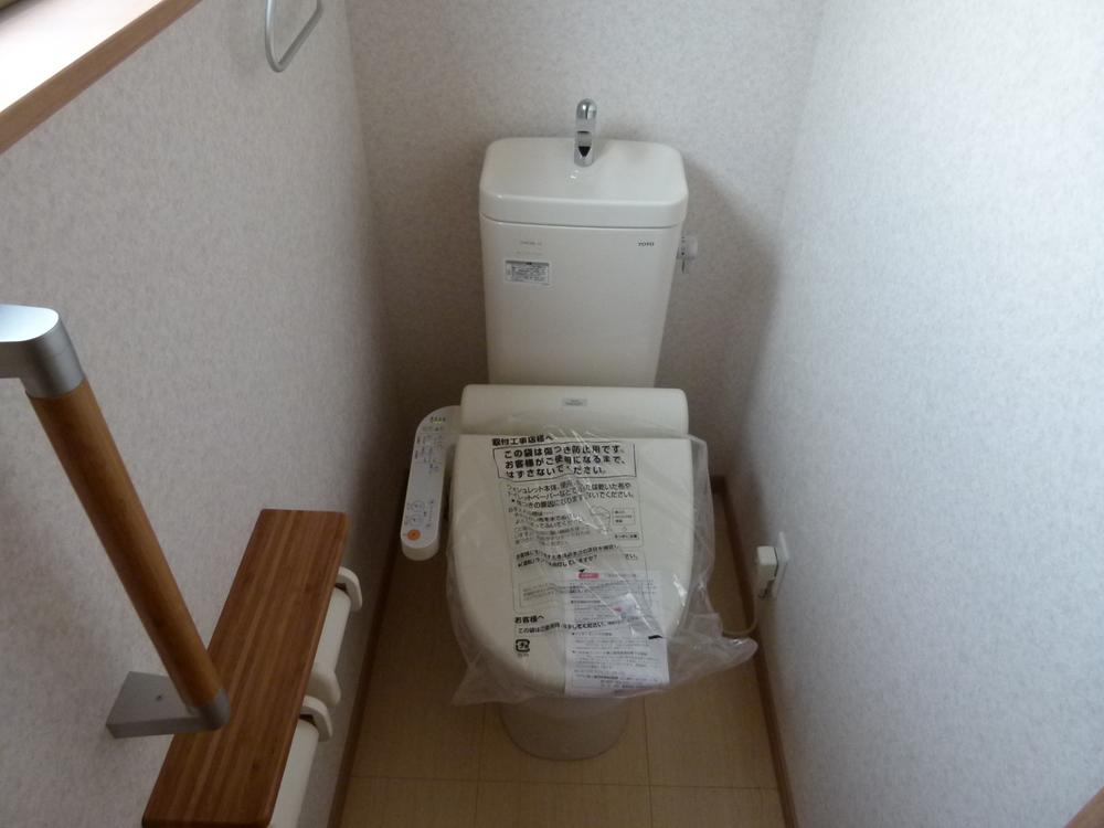 Toilet. Hot water is a function with a toilet seat