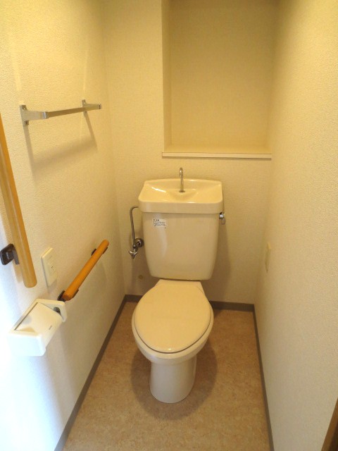 Toilet. With handrail