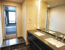 Washroom. 2 bowl vanity, Floor is bonded natural stone.