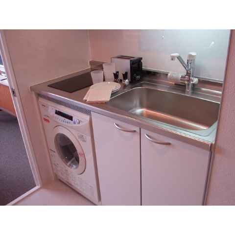 Kitchen. With a drum-type washing machine.