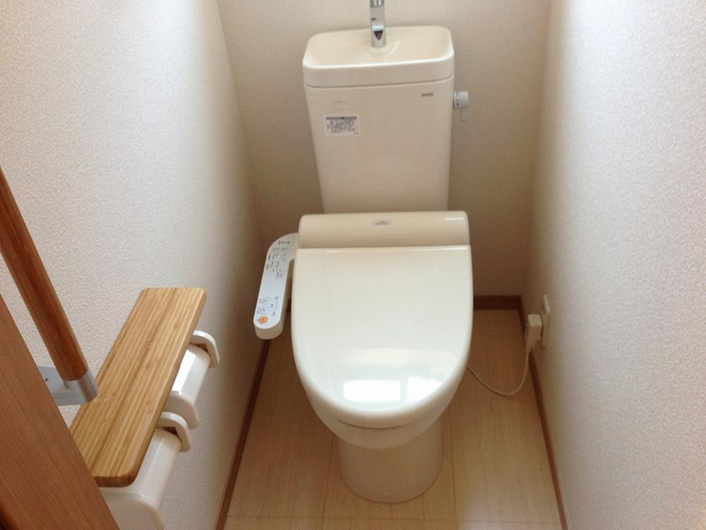 Toilet. Toilet is equipped with washing machine.