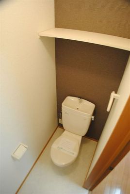 Toilet. With a convenient shelf to the toilet