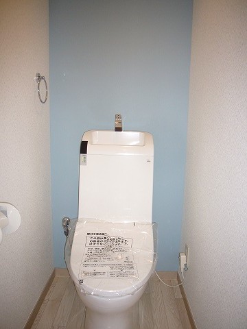 Toilet. It has worked cute light blue cross! Bidet equipped