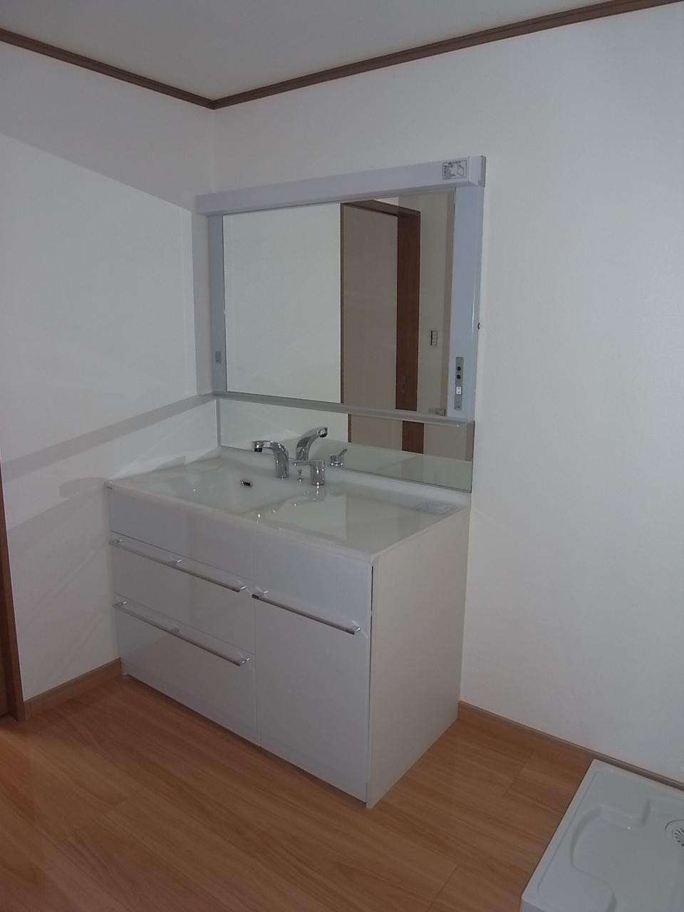 Wash basin, toilet. Vanity mirror is large