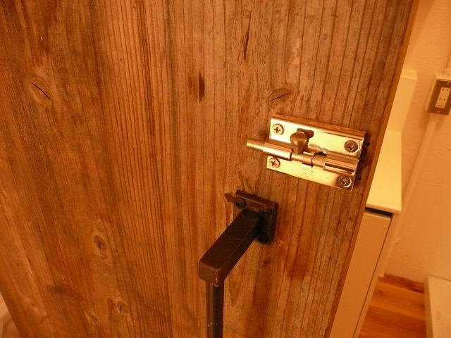 Other introspection. Bathroom door. Door handles and iron wood, Fashionable golden key.