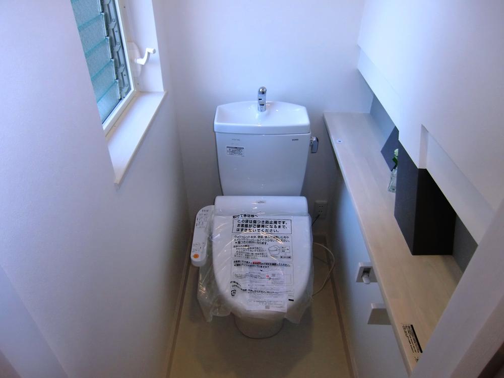 Toilet. Indoor (12 May 2012) shooting warm water toilet seat, Bidet with toilet. It puts such decorations to counter.