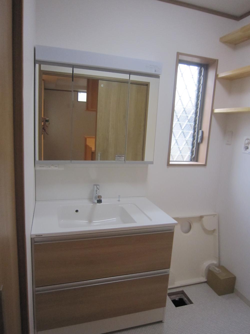 Wash basin, toilet. Basin dressing of friendly impression door handle of wood tone