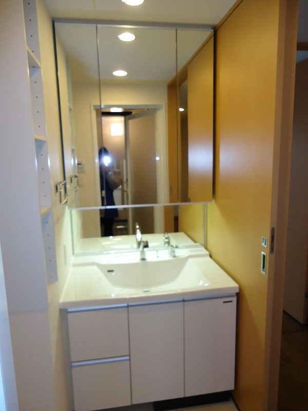 Washroom. Shampoo is a dresser with a three-sided mirror