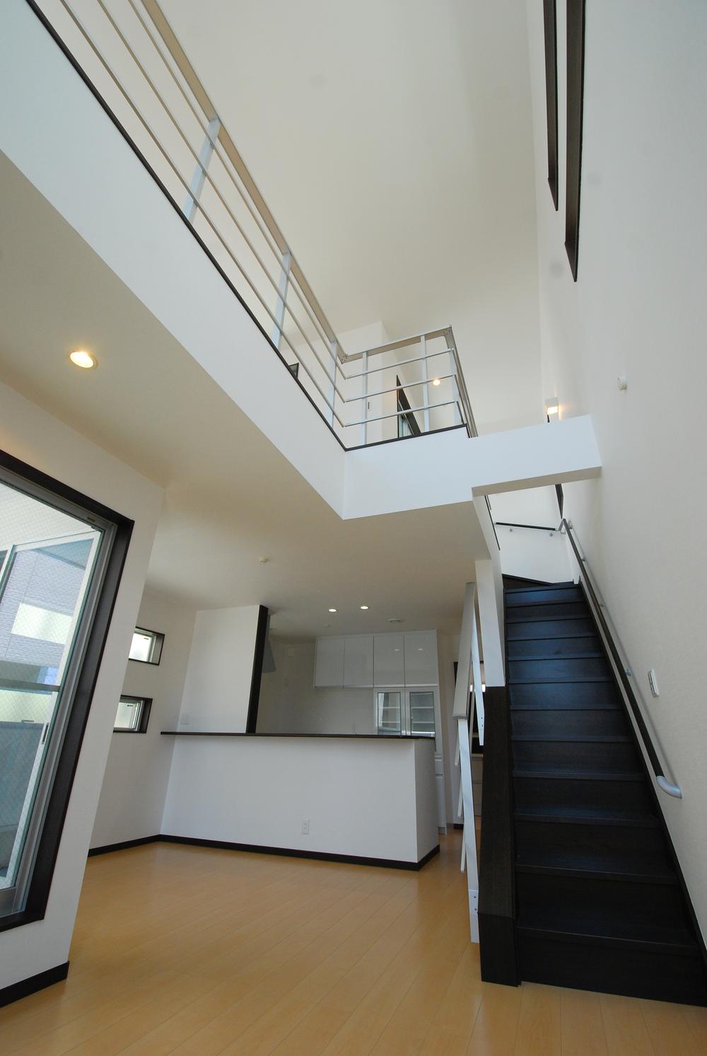 Living. Large space that leads to the second living from living in the skeleton stairs