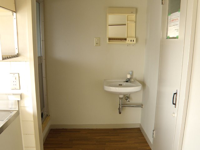 Washroom. Simple independent wash basin. Laundry Area is located next to.