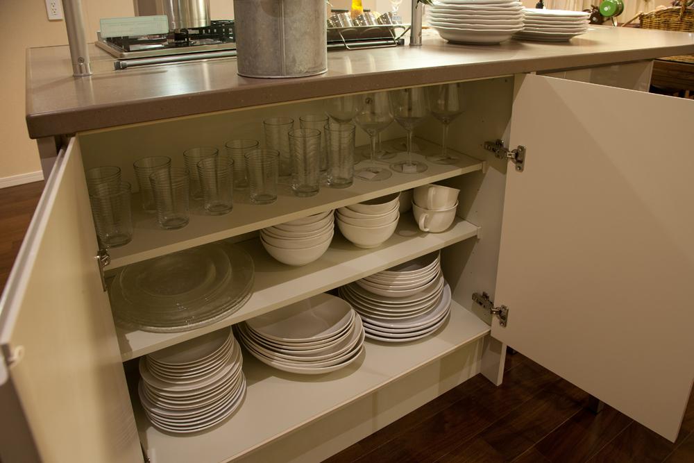 Other Equipment. High cupboard of storage capacity that is built into the kitchen counter next to.