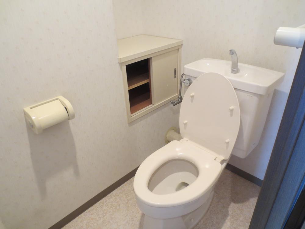 Toilet. It has a convenient storage attached to the toilet
