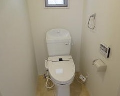Toilet. There is a small window