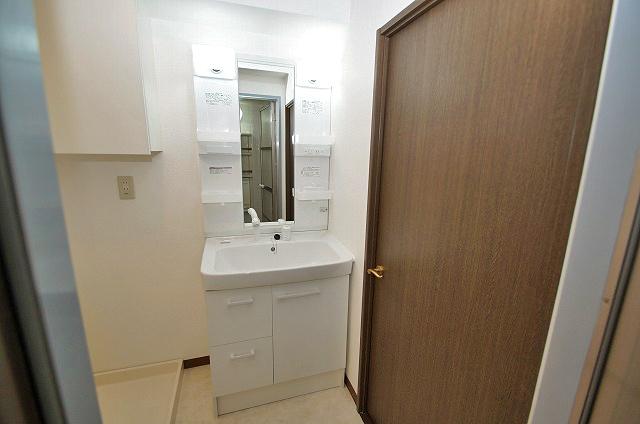 Wash basin, toilet. Vanity had made with shower