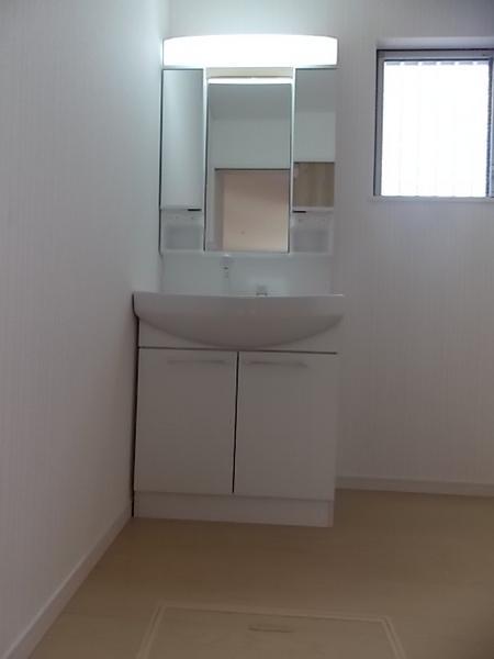 Wash basin, toilet. Bright wash room in with a small window