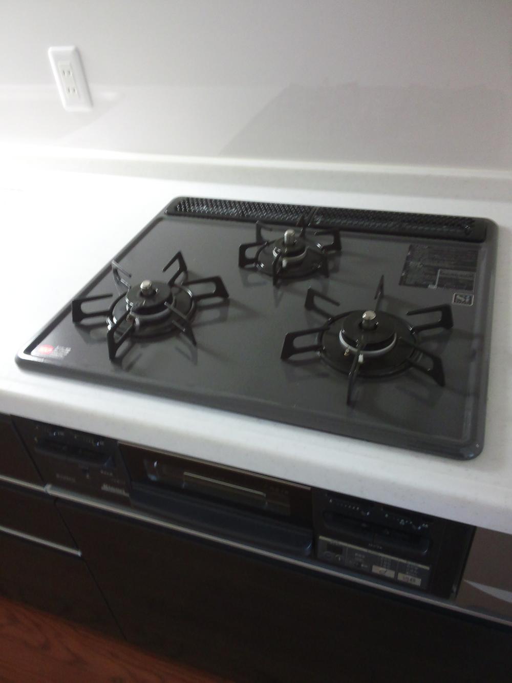 Kitchen. Happy to be cooking because it is a three-necked gas stove