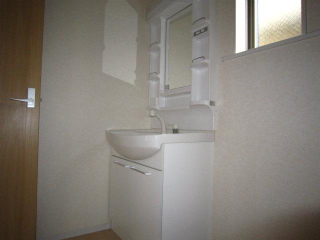 Wash basin, toilet. Wash basin is with a shower head