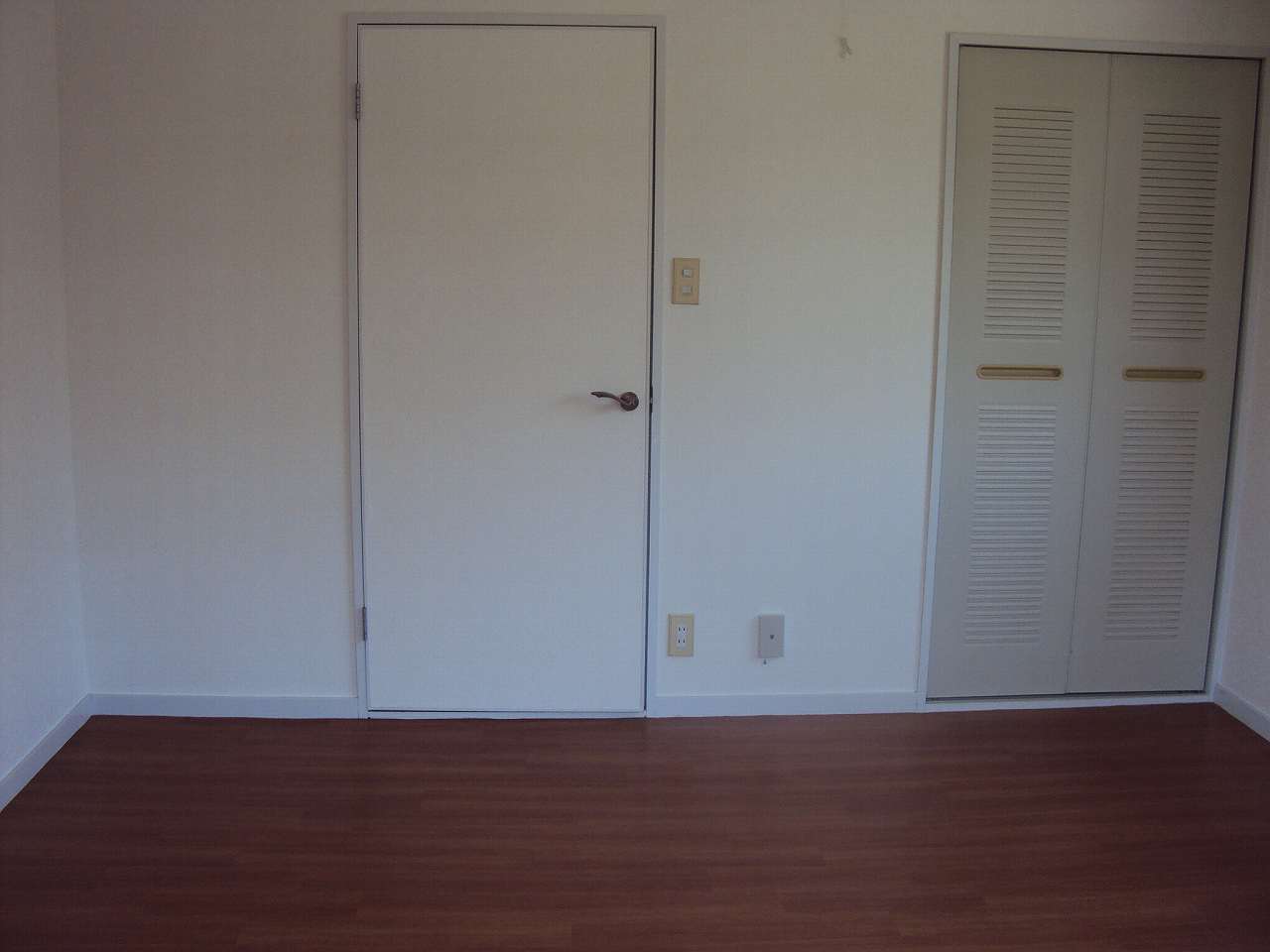 Other room space. There is a door between the kitchen and the room