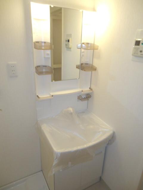 Wash basin, toilet. Noritsu made vanity
