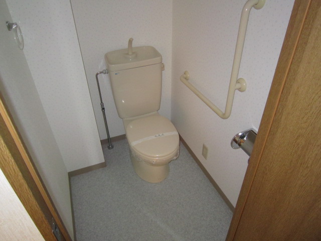 Toilet. With handrail