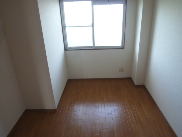 Other room space. It is bright and there is a window. 