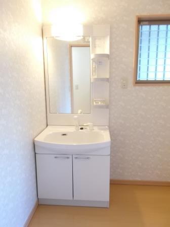 Wash basin, toilet. Dresser with shower is a great help to busy morning