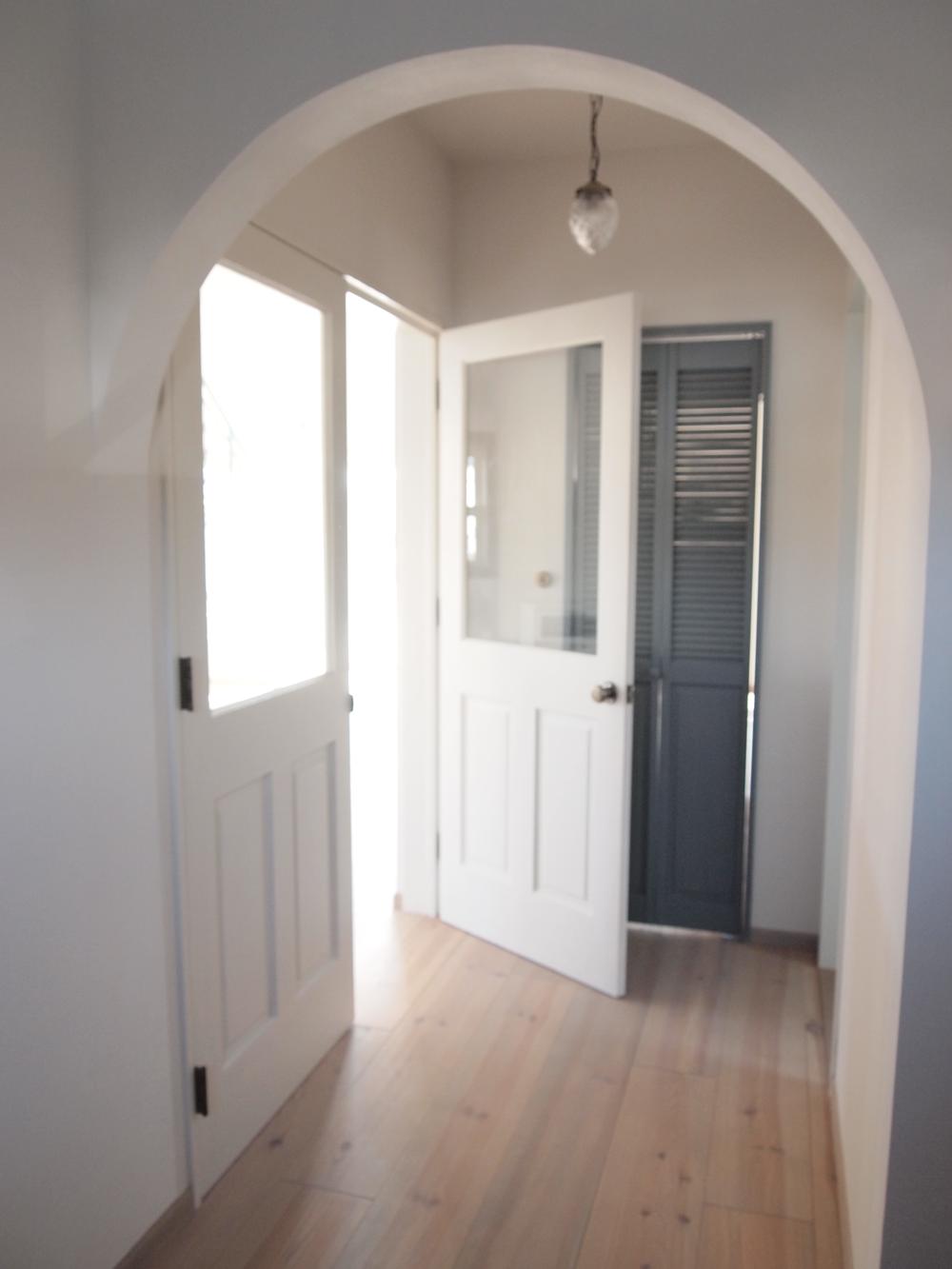 Other. Living door direction from the hallway. Corridor of arch ceiling exudes a stylish space.