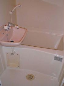 Bath. It is pure white bath equipped with a wash basin.