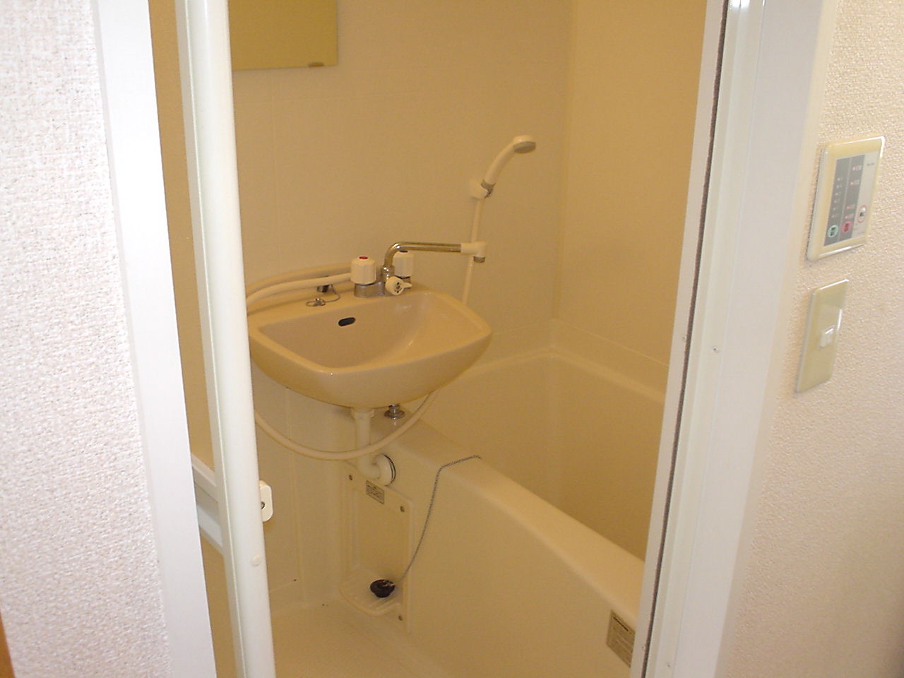 Bath. It is a bathroom with a shower. It is with a bathroom ventilation dryer.